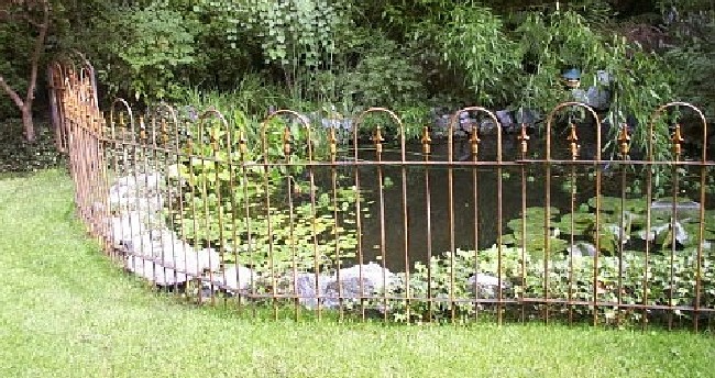 Fence around a pond to keep herons away
